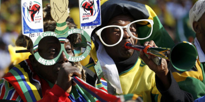South African fans blow the "vuvuzela" trumpets before the 2010 World Cup opening match between Mexico and South Africa at Soccer City stadium in Johannesburg